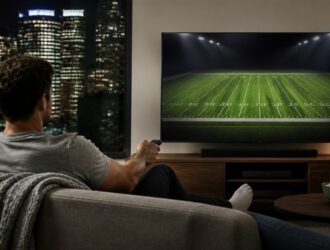 Viewer watching a generic football field scene at home.