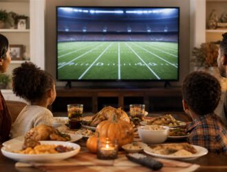 Family watching a generic football field during a holiday meal.